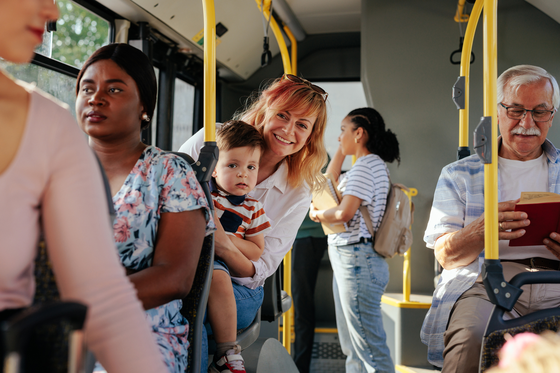 Happy mother and child on busy bus